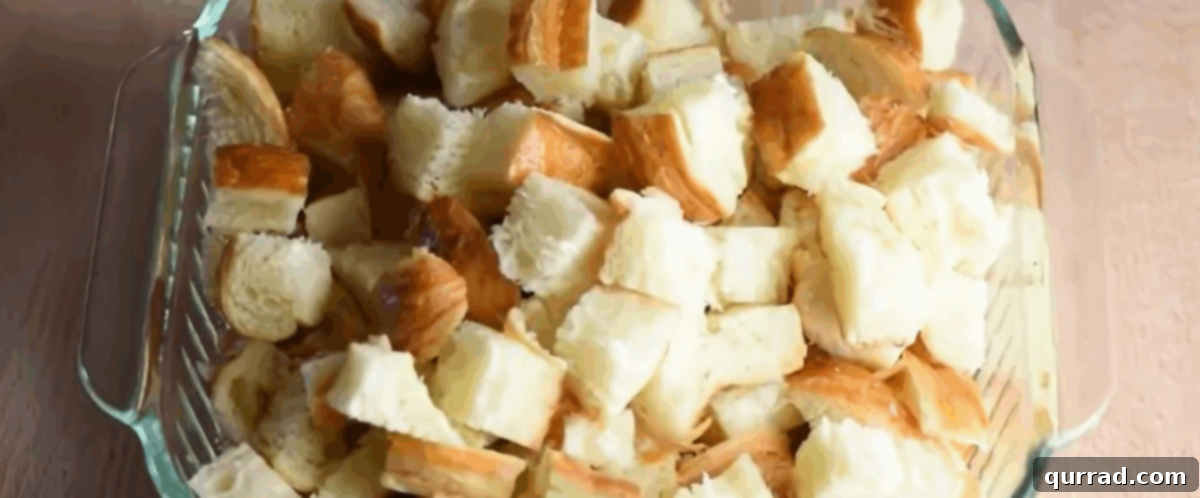 Decadent Croissant Bread Pudding 3 Glass casserole dish with cut up croissants.