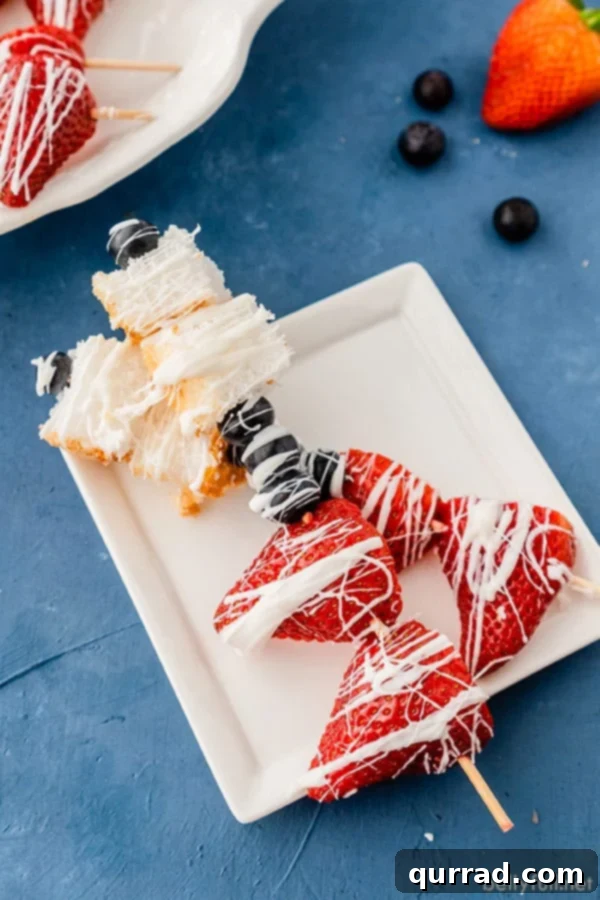 Effortless Fruit Dessert Skewers 4 two red white blue dessert fruit kabobs on white plate