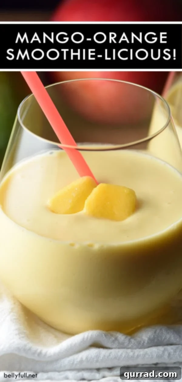 Close-up of a glass of Easy Mango Orange Smoothie, garnished with a mango slice