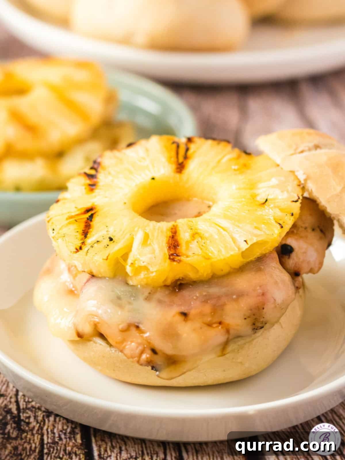 Aloha Grilled Chicken Stack 4 An open-faced Hawaiian chicken sandwich showing the grilled chicken, melted cheese, and pineapple slice