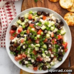 Vibrant Mediterranean Layered Dip 8 Full Greek Layered Dip, ready to serve, in a white ceramic dish