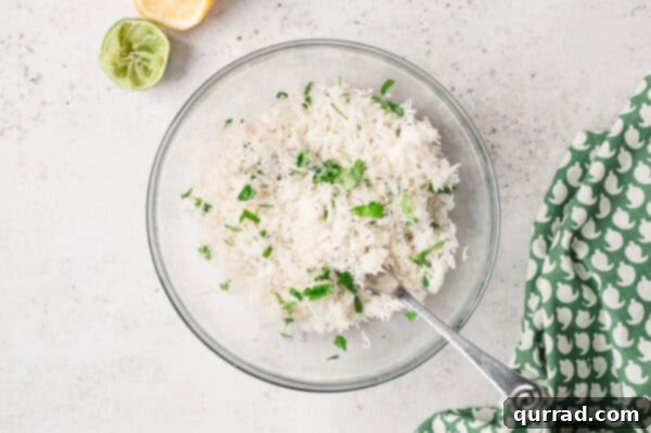 Restaurant-Quality Chipotle Steak Burrito at Home 6 cilantro lime rice in glass bowl with mixing spoon