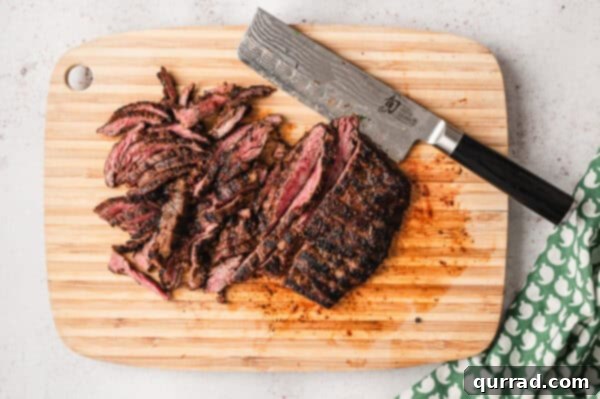 Restaurant-Quality Chipotle Steak Burrito at Home 8 sliced grilled steak on cutting board with knife