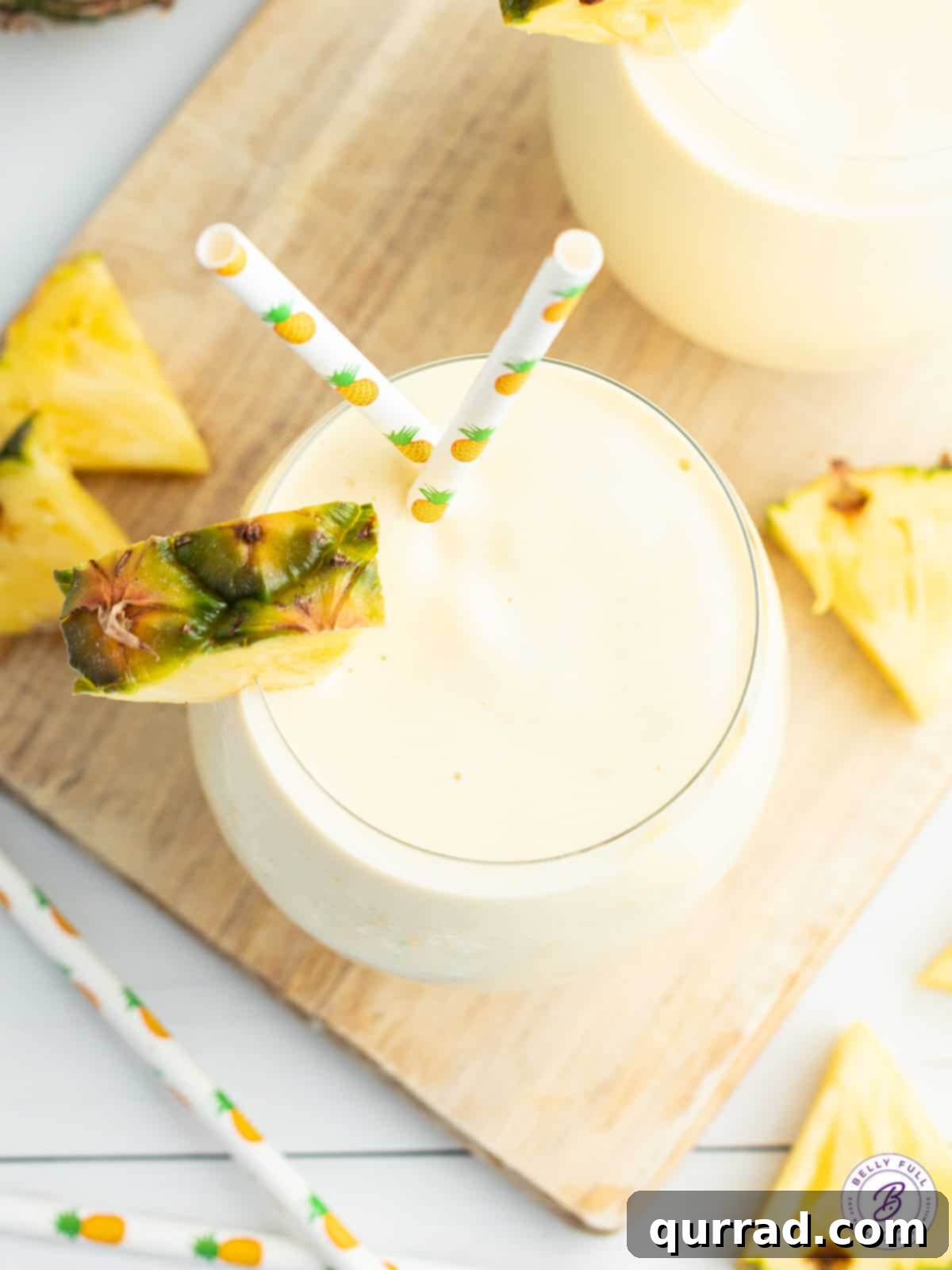Sun-Kissed Pineapple Blend 3 overhead smoothie with pineapple wedge garnish