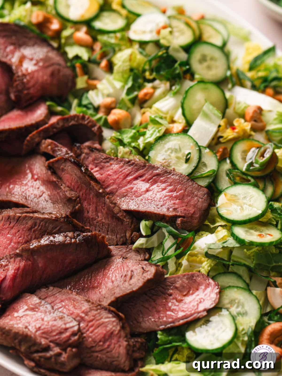 Ginger-Sesame Steak Salad 2 close up sliced grilled steak with cucumber salad