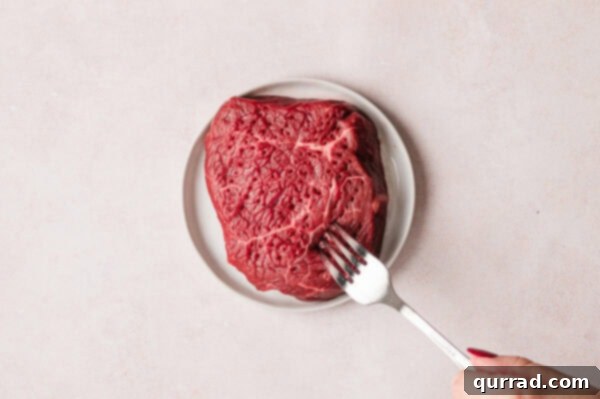 Ginger-Sesame Steak Salad 4 fork pricking uncooked steak