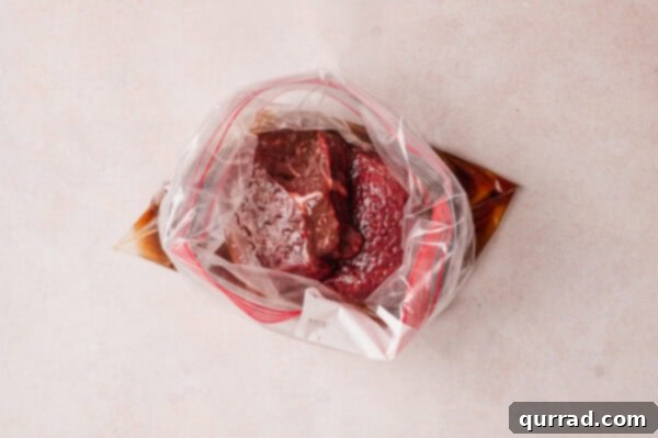 Ginger-Sesame Steak Salad 5 overhead uncooked steak in marinade in plastic bag