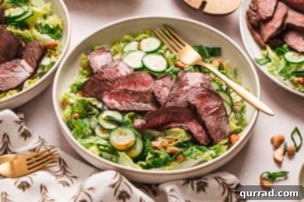 Ginger-Sesame Steak Salad 8 sliced grilled steak on top of salad with cucumbers