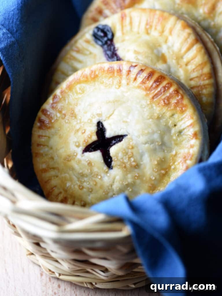 Sweet Blueberry Handheld Treats 2 Blueberry hand pies in basket with blue cloth napkin