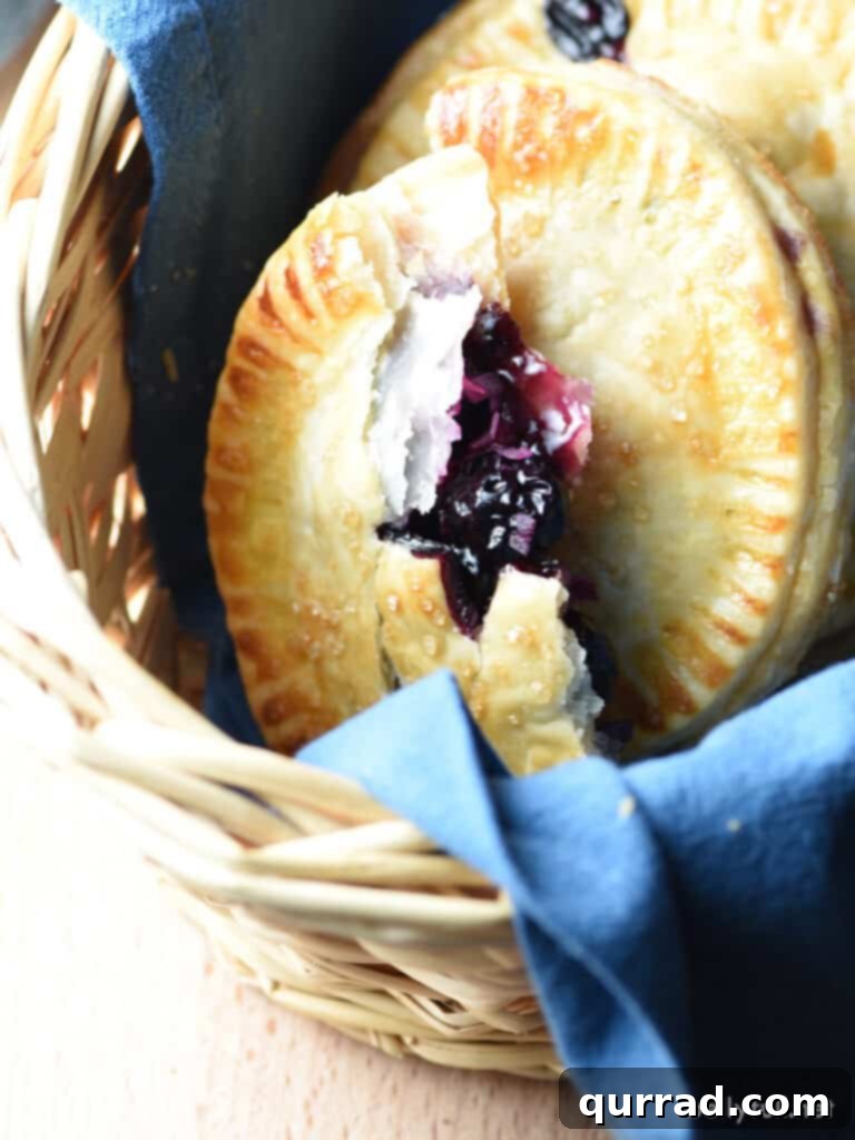 Sweet Blueberry Handheld Treats 4 blueberry hand pie cut in half with filling exposed