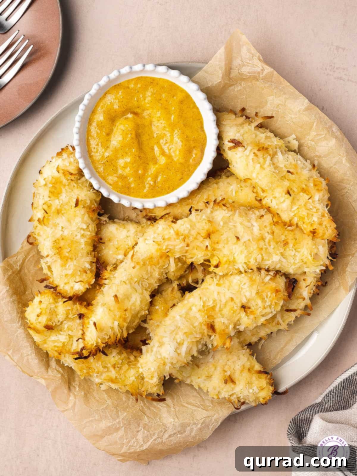 Coconut Crusted Baked Chicken Tenders 2 overhead plate of coconut baked chicken tenders with dipping sauce