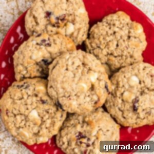 Chewy Cranberry Oat Delights 6 Overhead of oatmeal craisin cookies piled on a red plate, showcasing the recipe's delicious output.