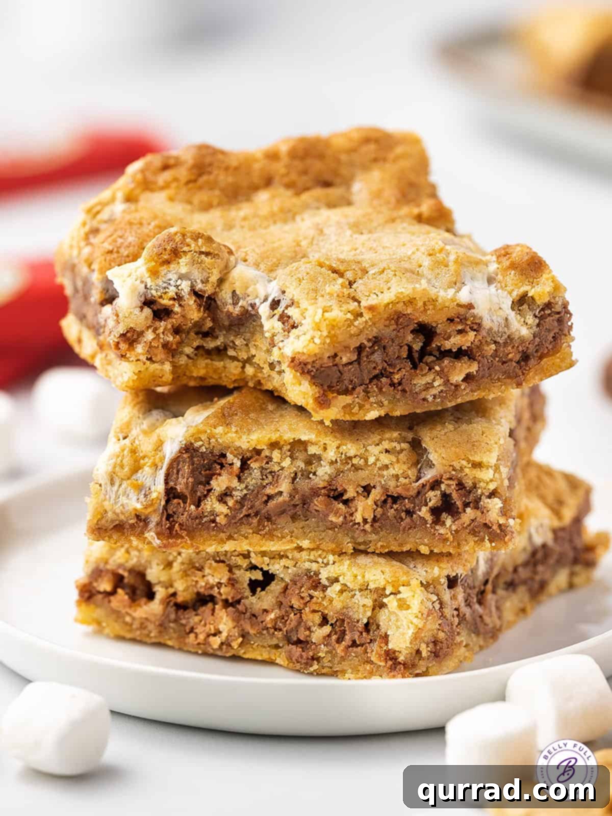 Kit-Kat S'mores Dream Bars 4 A close-up stack of three irresistible Kit Kat S'mores bars, showing their layered goodness and golden-brown marshmallows.