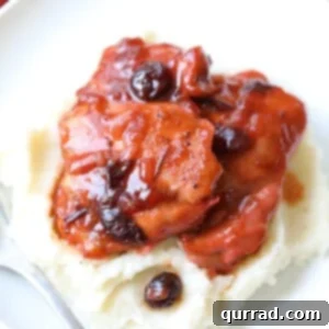 Cranberry Glazed Chicken 3 Close-up of golden-brown cranberry chicken pieces in a baking dish, ready to be served.