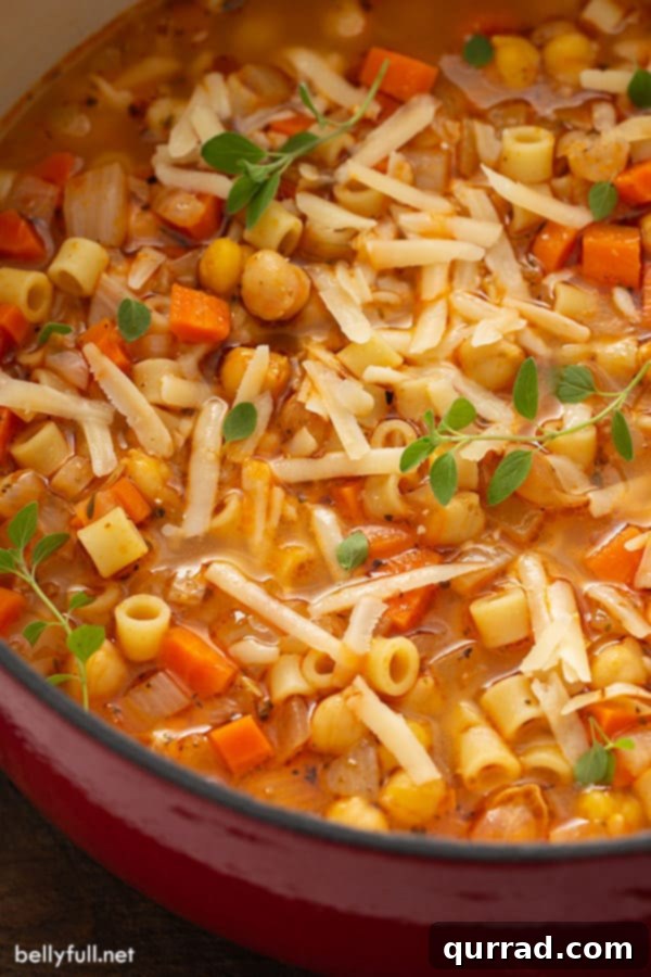 Hearty Pasta and Chickpea Stew 3 Close-up of a pot filled with Pasta e Ceci, highlighting the tender chickpeas and ditalini pasta in a rich, simmering tomato broth.