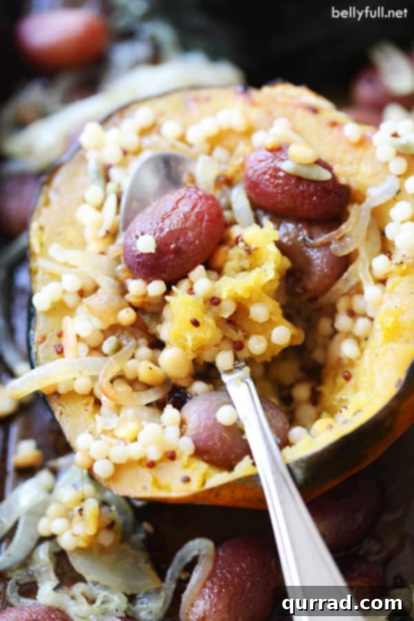 This Stuffed Acorn Squash has that wow factor! Filled with grains, roasted grapes, and caramelized onions, it's a flavor explosion in every bite! #acornsquashrecipes #roastedacornsquash #stuffedacornsquash Stuffed Acorn Squash filled with roasted grapes and onions