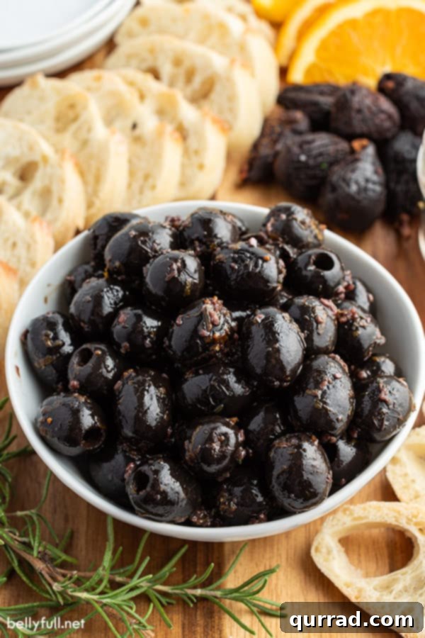 Fig Balsamic Infused Olives 2 Homemade marinated olives served in a white bowl, ready to be enjoyed.