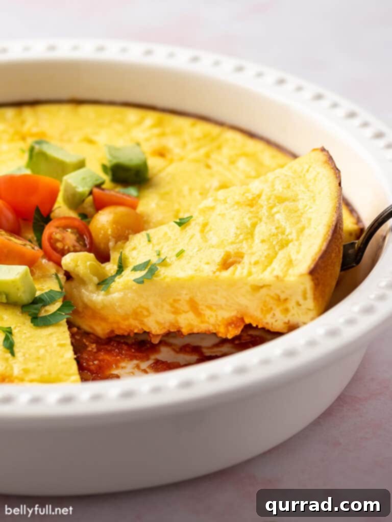 A slice of thick, fluffy Mexican Omelet Pie being lifted with a serving spoon.