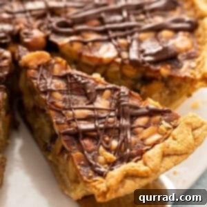 Close-up of a slice of turtle pie drizzled with chocolate on a serving spoon, representing the finished dish.