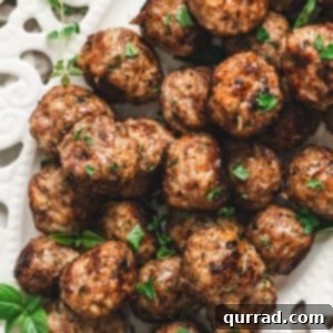 A close-up of a perfectly cooked Italian Meatball, highlighting its juicy interior and golden-brown exterior.