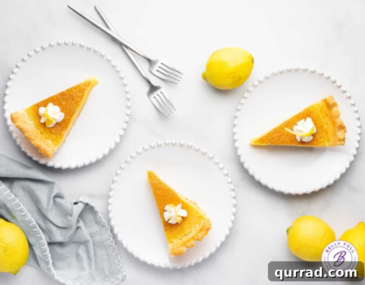 Overhead view of three slices of lemon pie arranged neatly on white plates