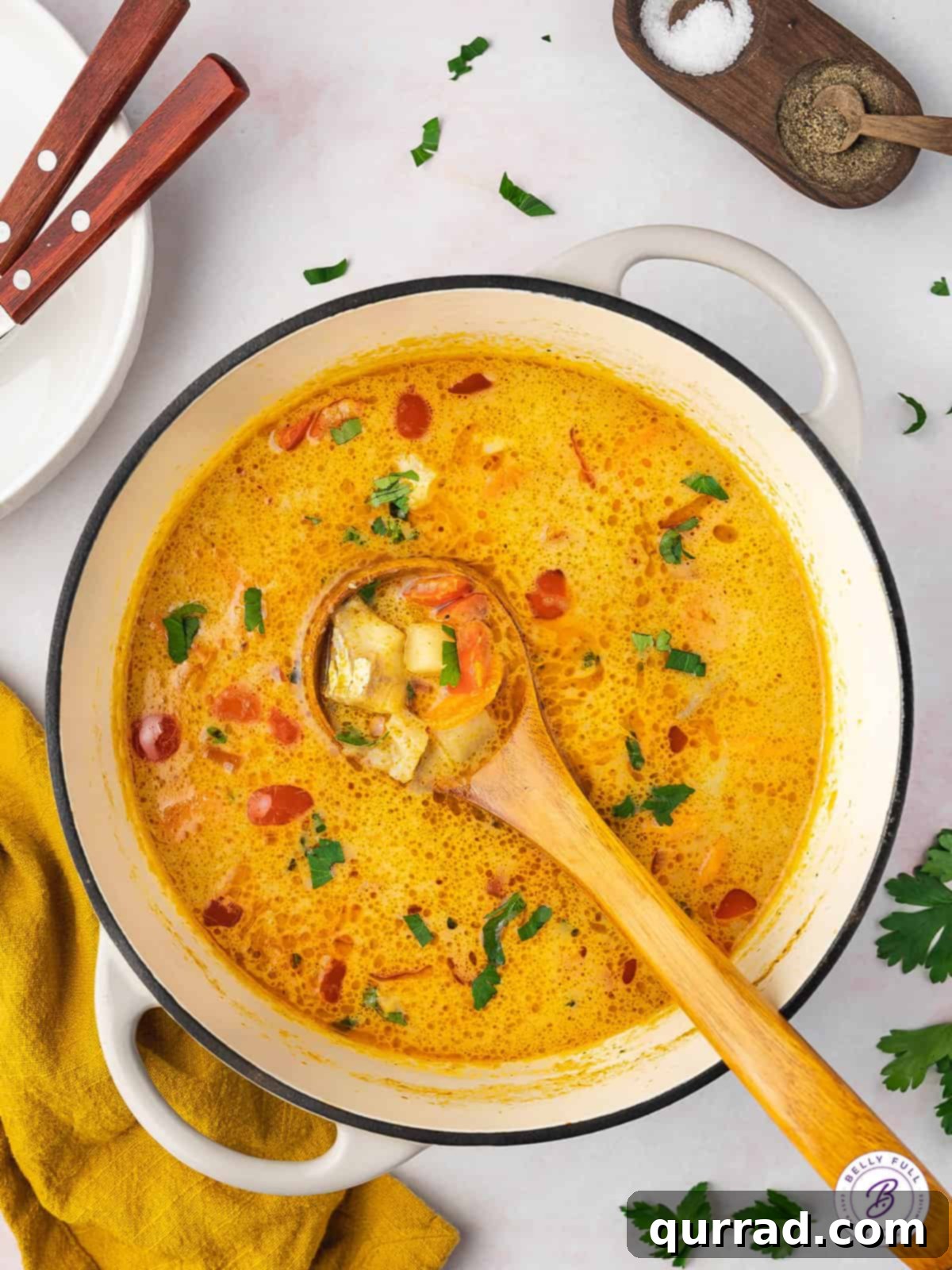 ladle full of yellow curry fish stew