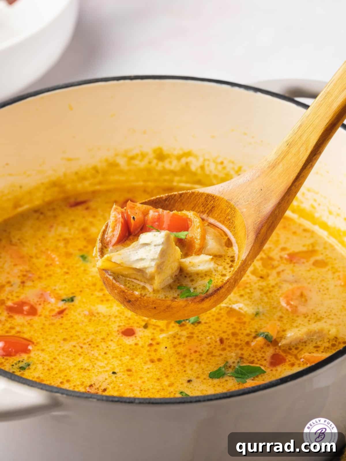 wooden ladle full of fish stew