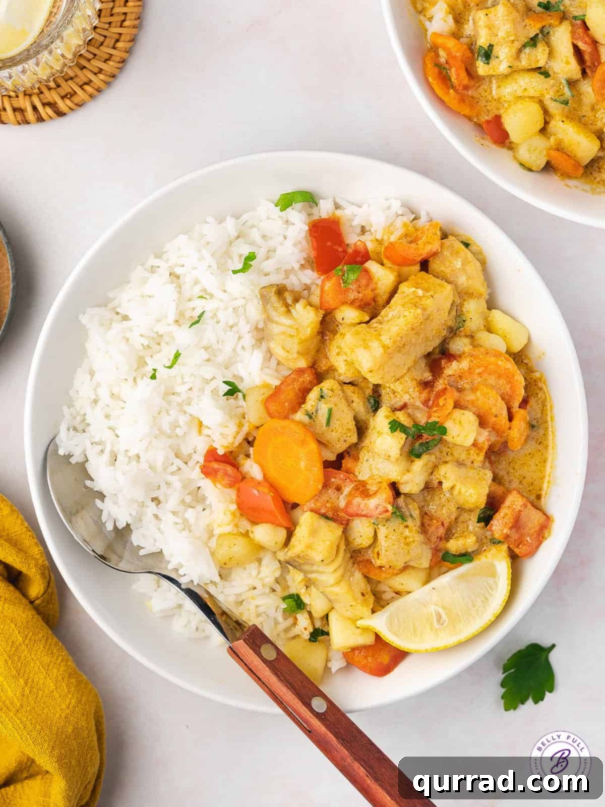 overhead bowl of thai fish curry with white rice