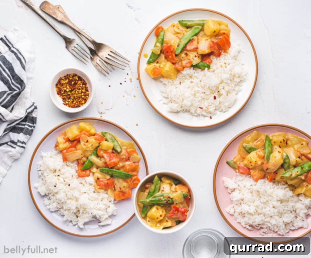 Effortless Veggie Wok 5 Three beautifully plated dishes of coconut curry veggie stir fry, each with white rice and garnished, ready for serving.
