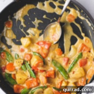 Effortless Veggie Wok 6 Overhead view of a coconut curry vegetable stir fry in a skillet, representing the recipe photo.
