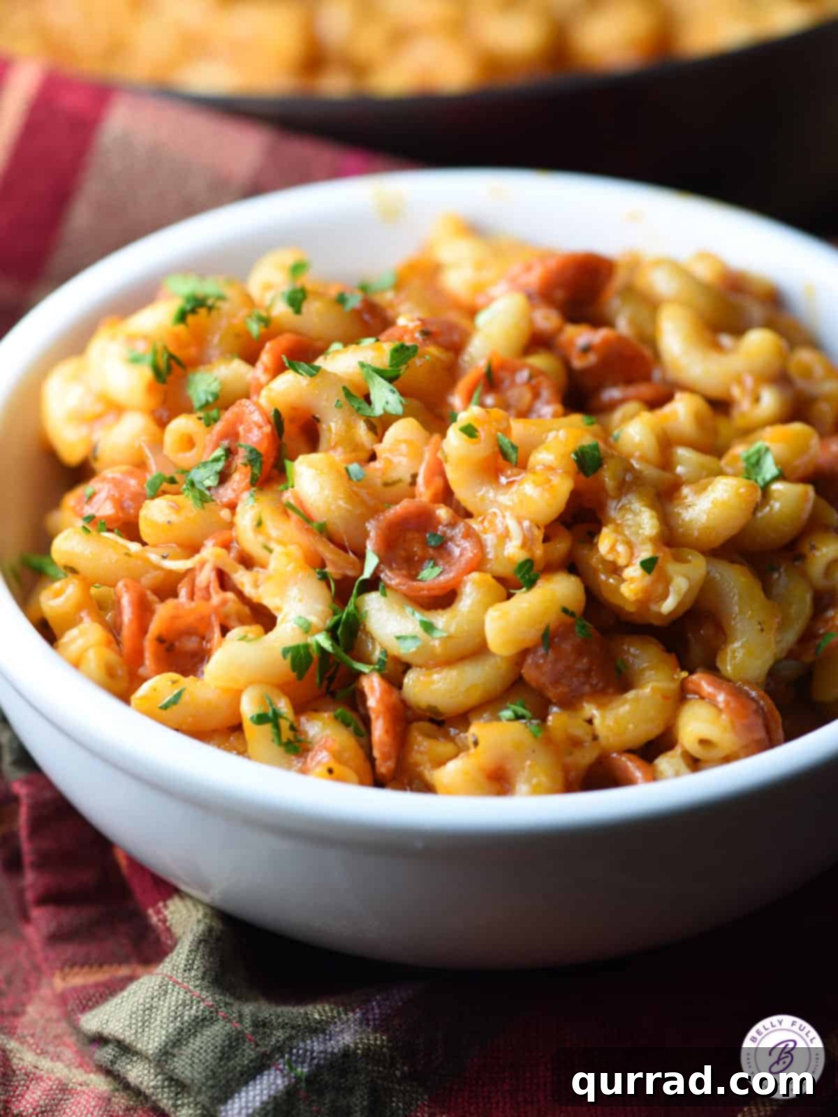Pizzaroni Mac and Cheese 8 A close-up of Pepperoni Pizza Macaroni and Cheese served in a white bowl, showing the creamy texture and pepperoni pieces.