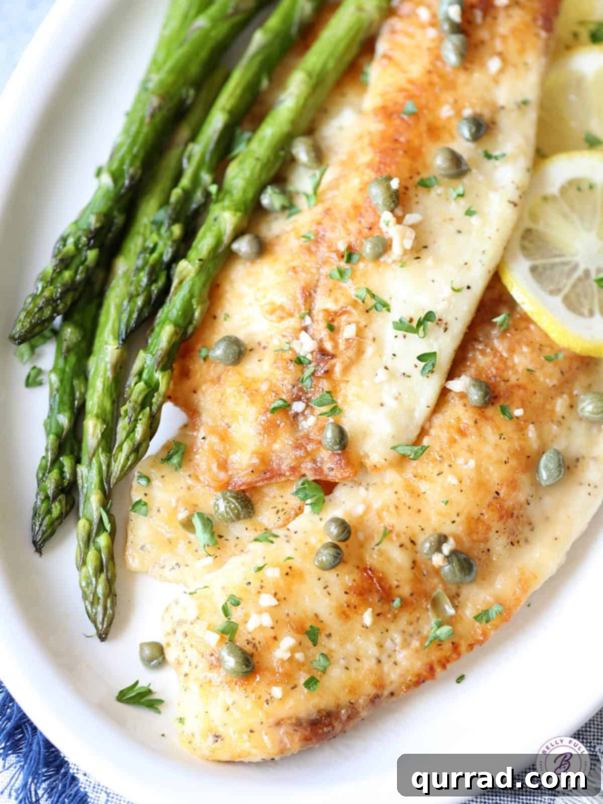 Zesty Lemon-Caper Fish 5 overhead fish piccata on plate with garlic and capers