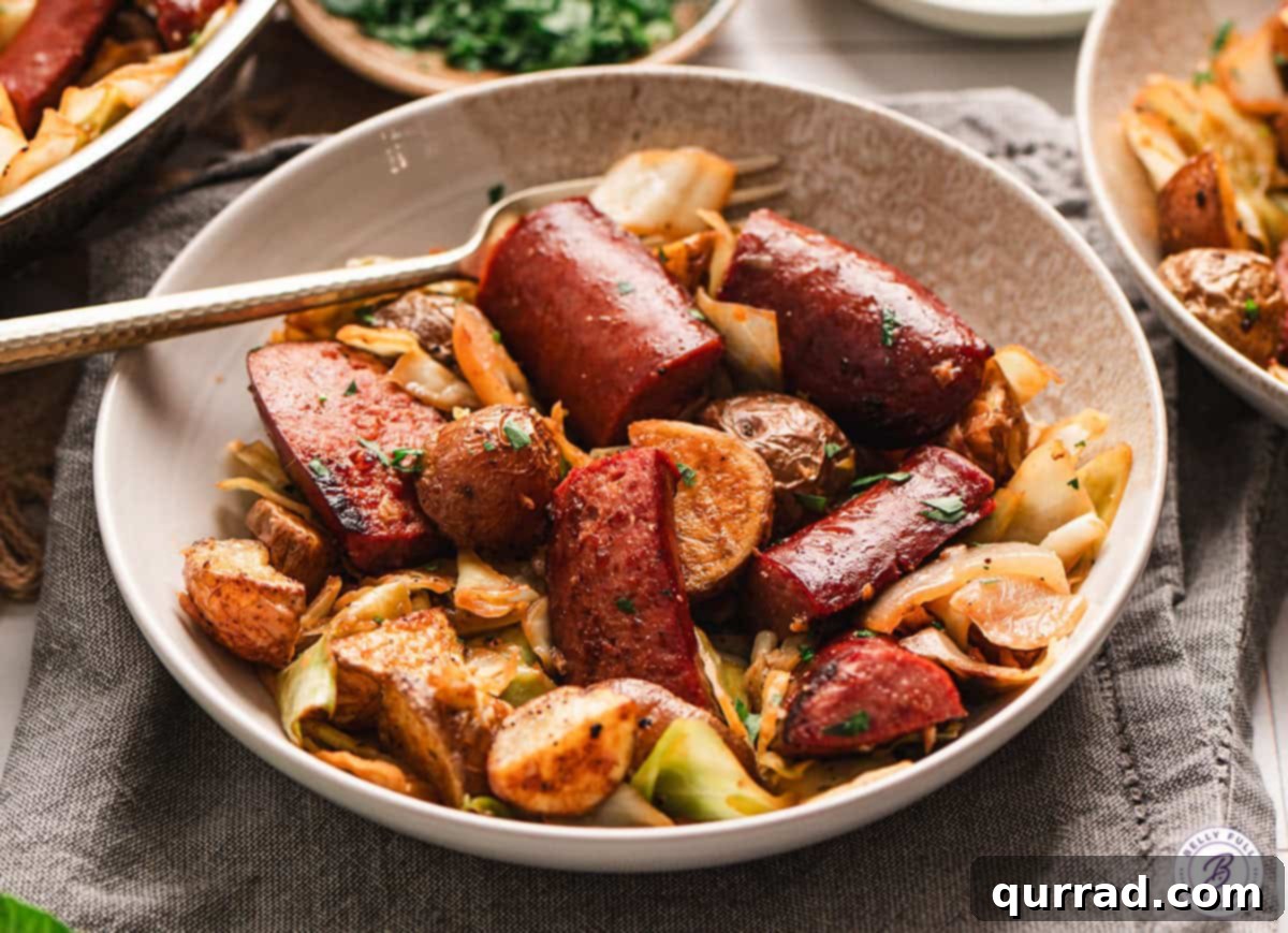 Another view of the delicious Kielbasa and Cabbage Skillet with roasted potatoes in a serving bowl.