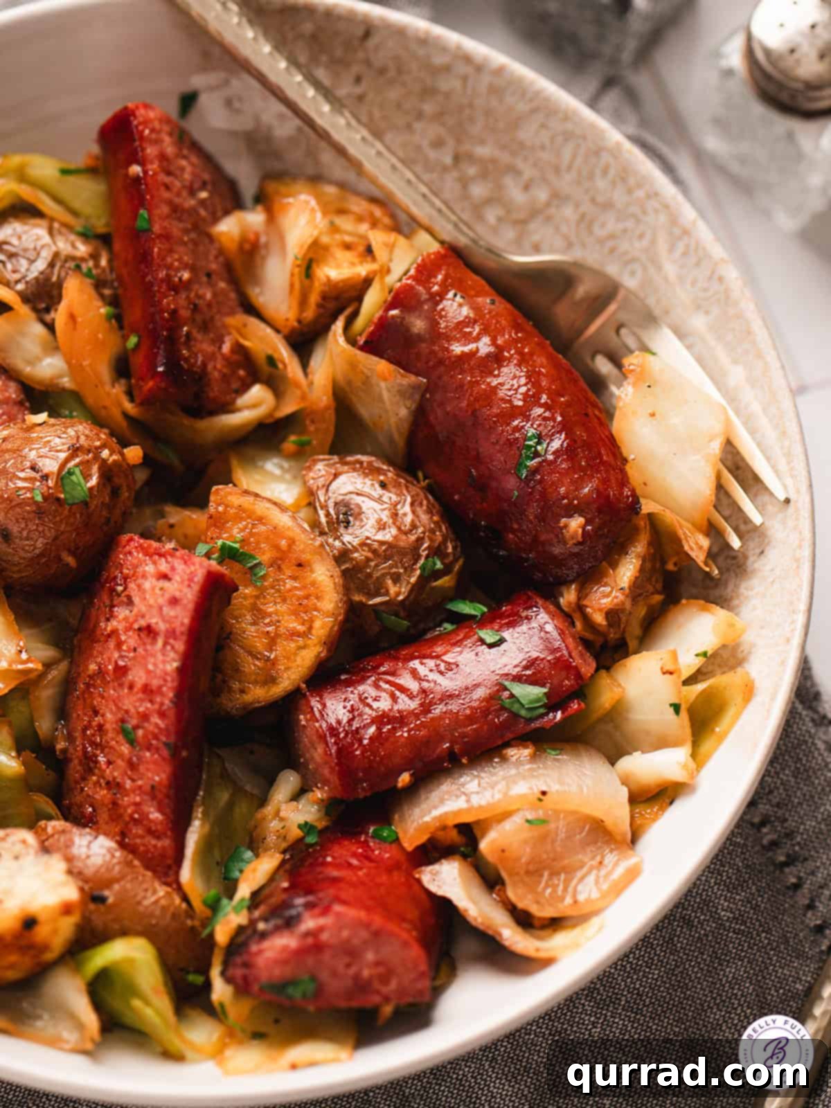 Beautifully arranged Kielbasa and Cabbage Skillet in a serving bowl, garnished and ready to eat.