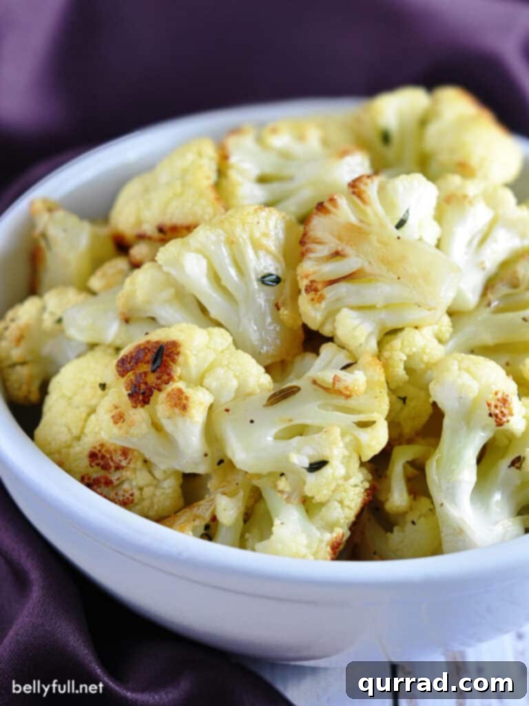 Crispy Parmesan Roasted Cauliflower 3 roasted cauliflower in serving bowl with purple napkin