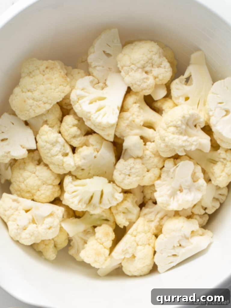 Crispy Parmesan Roasted Cauliflower 4 raw cauliflower florets in white bowl