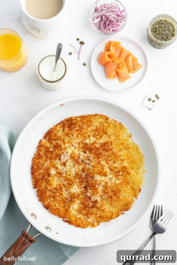 Overhead shot of golden, crispy hash browns sizzling in a cast-iron skillet, showcasing their perfect texture.
