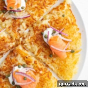 Close-up of crispy hash browns on a white plate, ready to be served