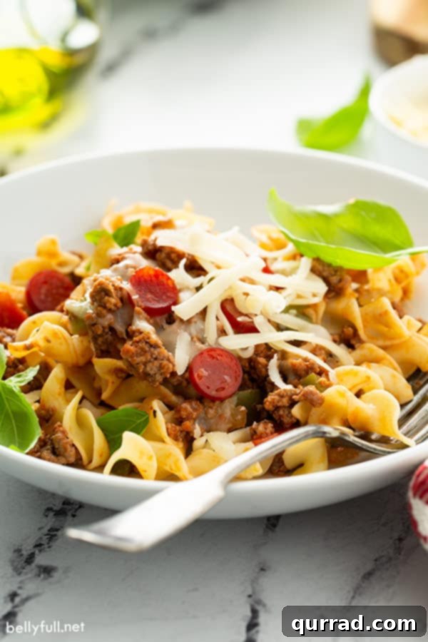 Cheesy Pizza Noodle Bake 6 pizza pasta in white bowl with fork