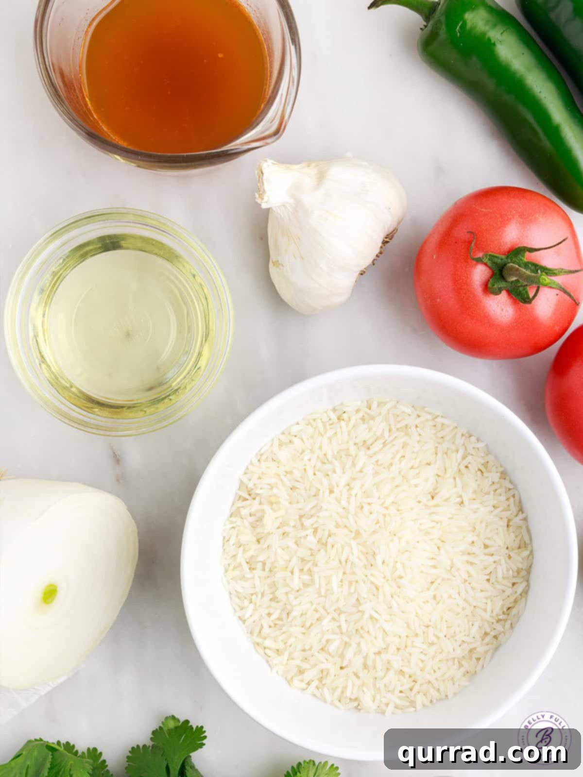 Vibrant Spanish Rice 3 Fresh ingredients laid out for making Mexican rice, including onions, bell pepper, garlic, rice, and Rotel can