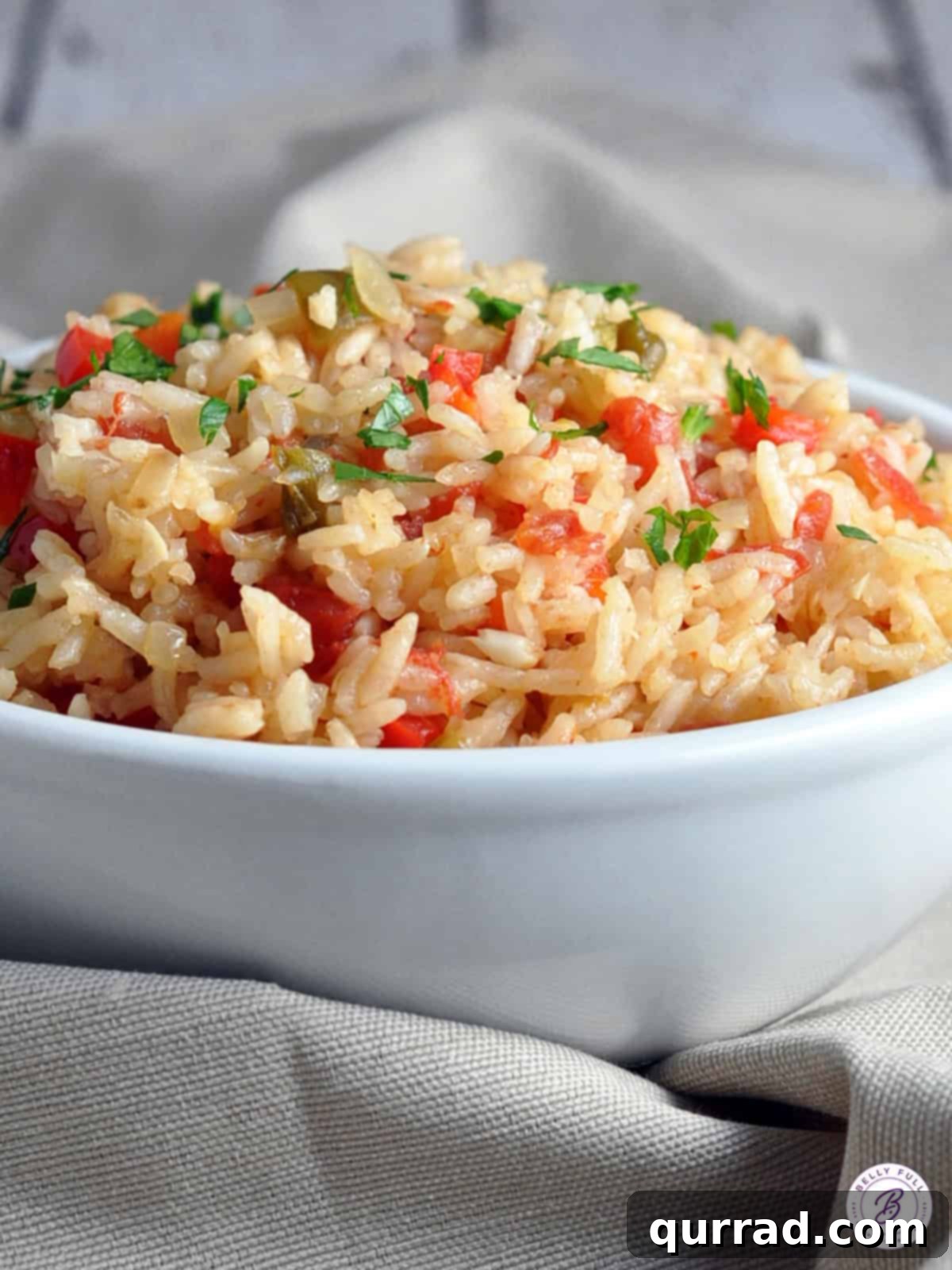 Vibrant Spanish Rice 4 Close-up of a bowl of fluffy Mexican Rice, garnished with herbs