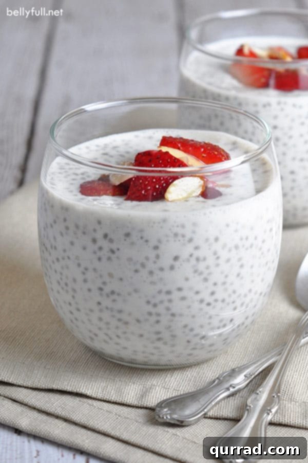 Wholesome Chia Delight 2 Two glass jars of chia seed pudding with spoons, topped with fresh berries