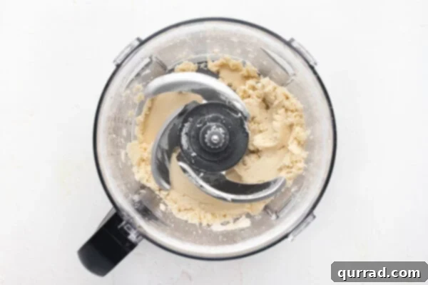 flour and vegetables shortening blended together in bowl of food processor