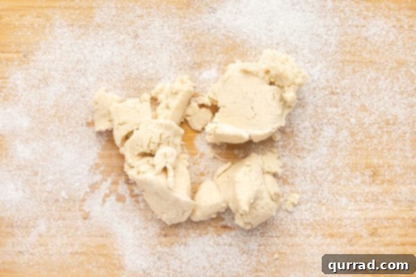 large pieces of pie crust dough on floured work surface