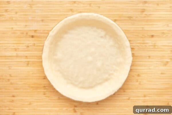 unbaked pie crust dough formed in pie plate