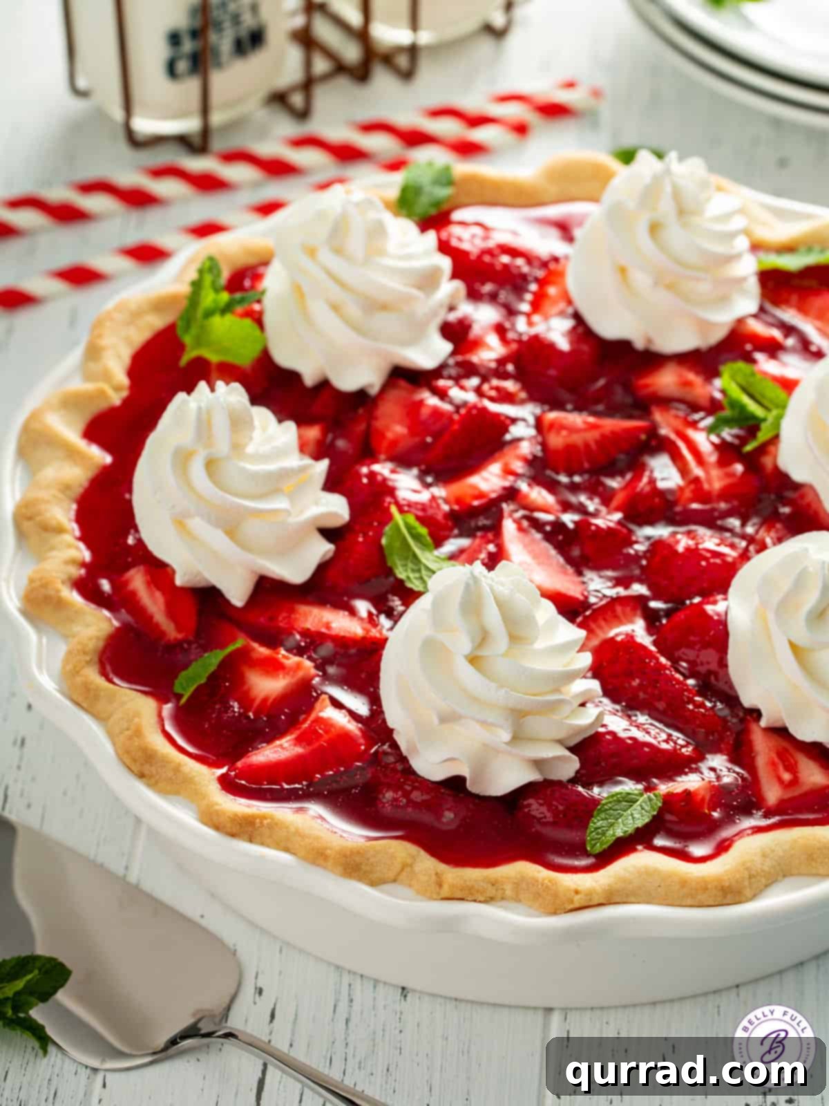 No-Fuss Fresh Strawberry Pie 8 Whole red fruit jello pie garnished with whipped cream.