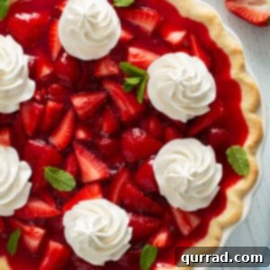 whole jello strawberry pie garnished with whipped cream
