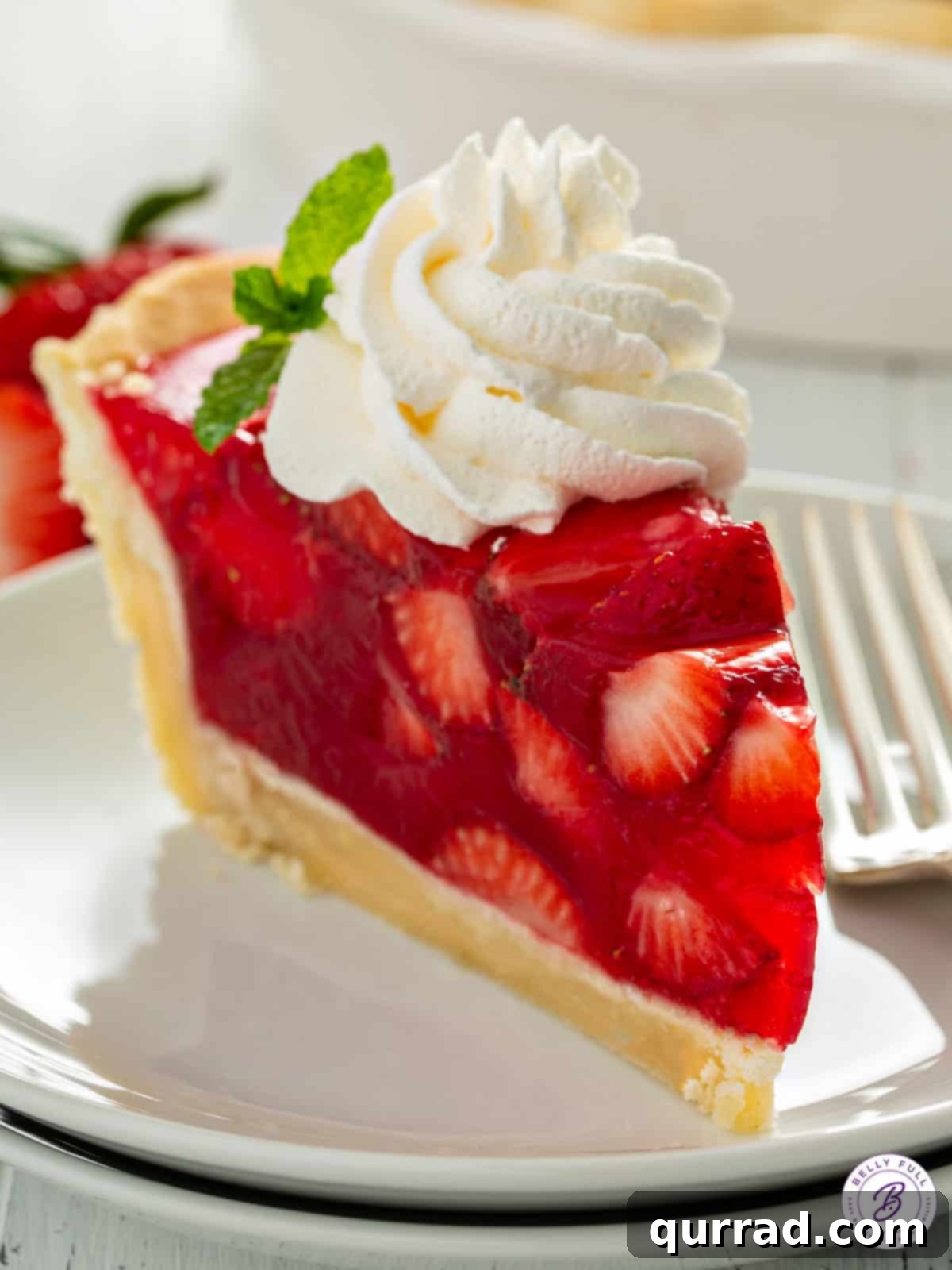 No-Fuss Fresh Strawberry Pie 7 Slice of jello fruit pie with whipped cream.