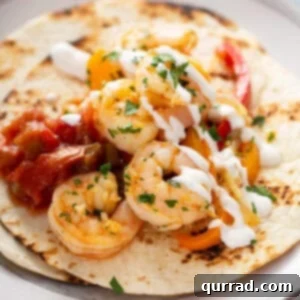 Cooked shrimp on flour tortilla with sour cream and salsa