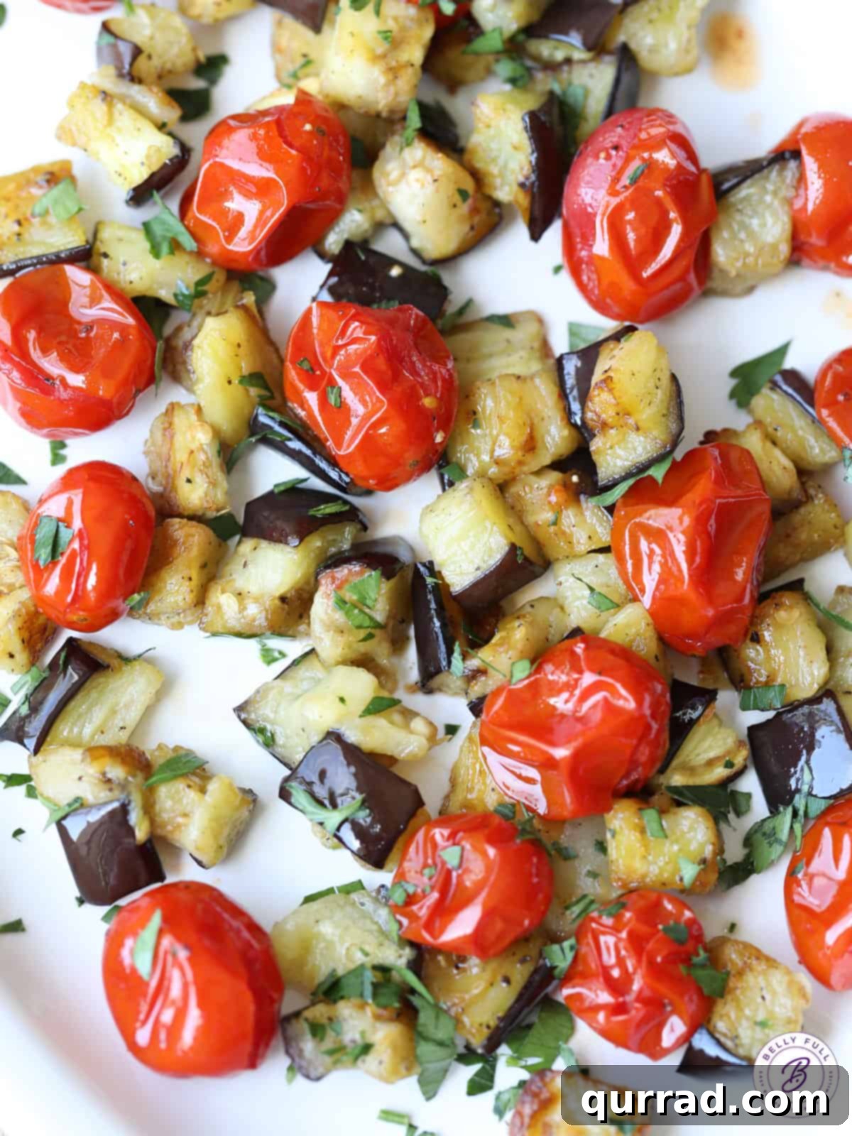 Savory Roasted Eggplant and Sweet Cherry Tomatoes 2 close up view of perfectly roasted eggplant and sweet cherry tomatoes, garnished with fresh parsley